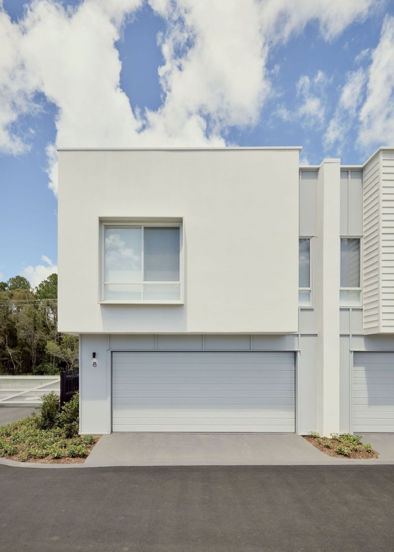 White rendered upper storey of an Elwood by Azure townhouse in Mango Hill above a double garage