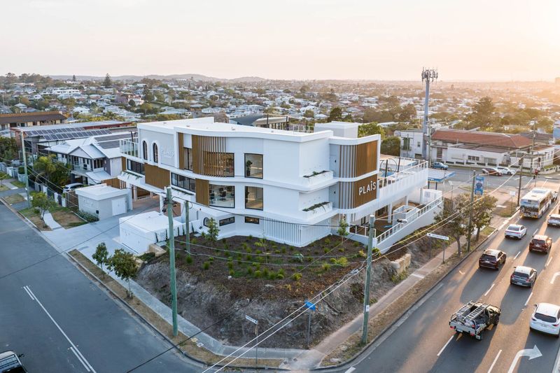 Aerial view of Plaîs Early Learning, a white rendered childcare centre on a corner block in Camp Hill